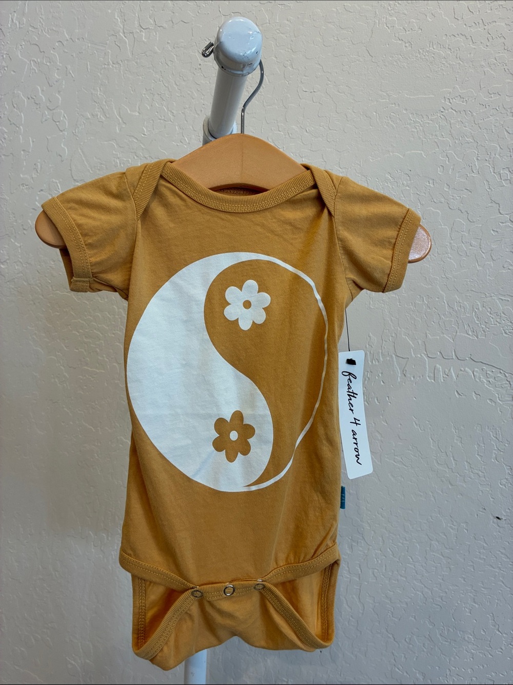 Mustard Yellow Baby Onesie with Yin Yang Flower Graphic